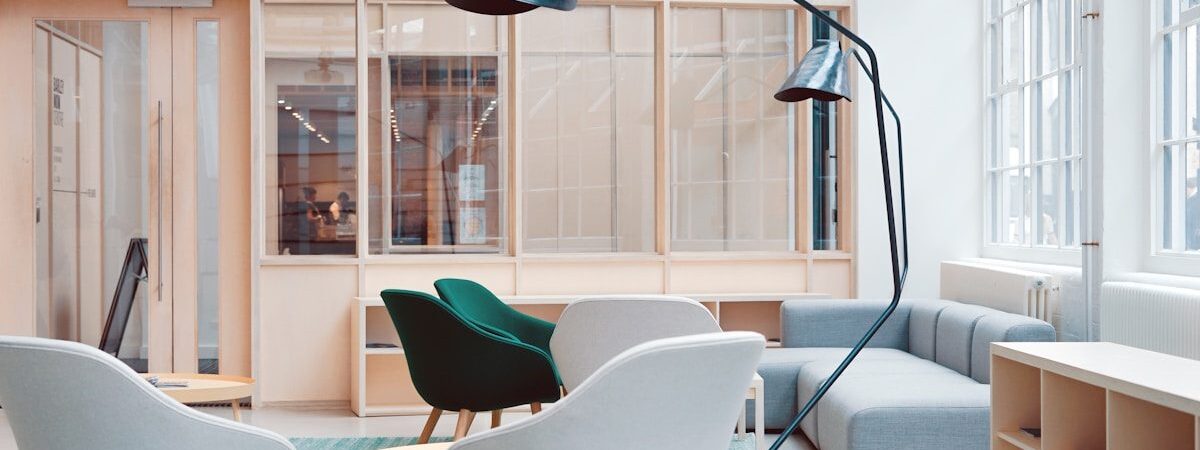 A daylit lounge and breakout space with soft seating.